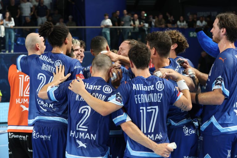 Équipe de handball célébrant ensemble sur le terrain.