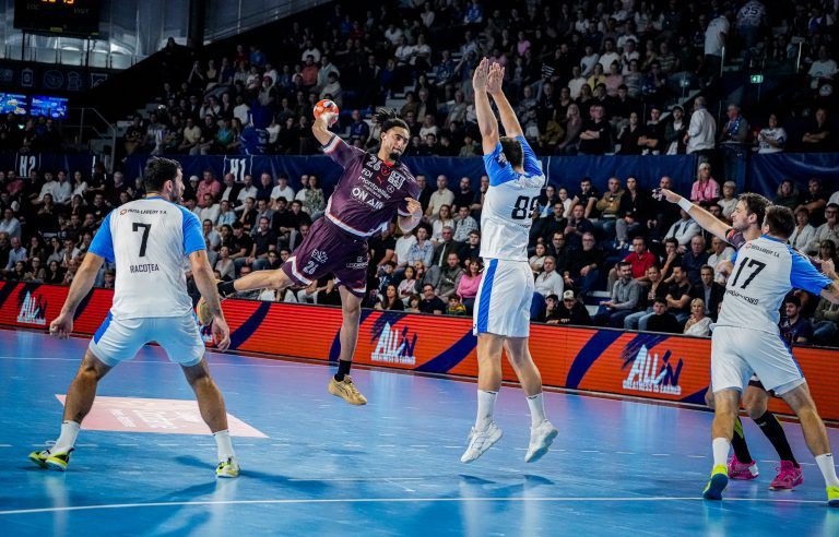 Match de handball en salle dynamique et énergique.