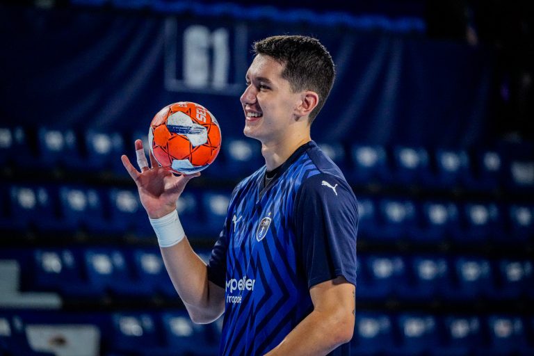 Joueur de handball souriant avec ballon en main.