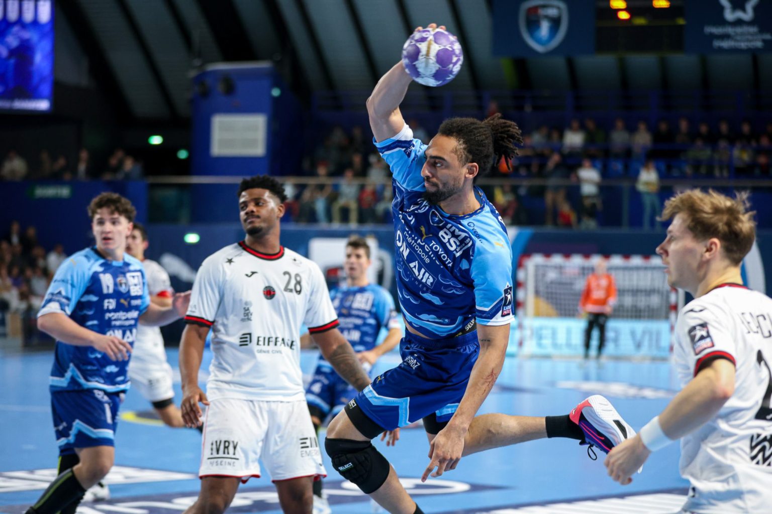 Match de handball en action, joueurs concentrés.