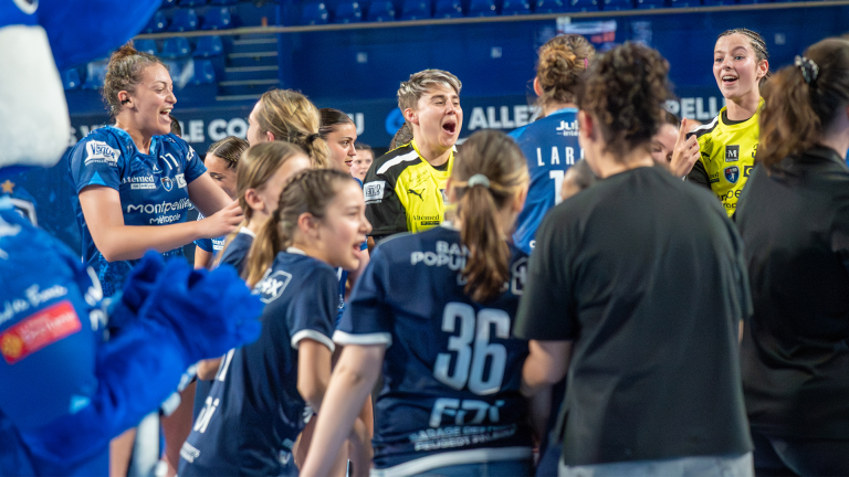 Équipe féminine de handball célébrant ensemble.