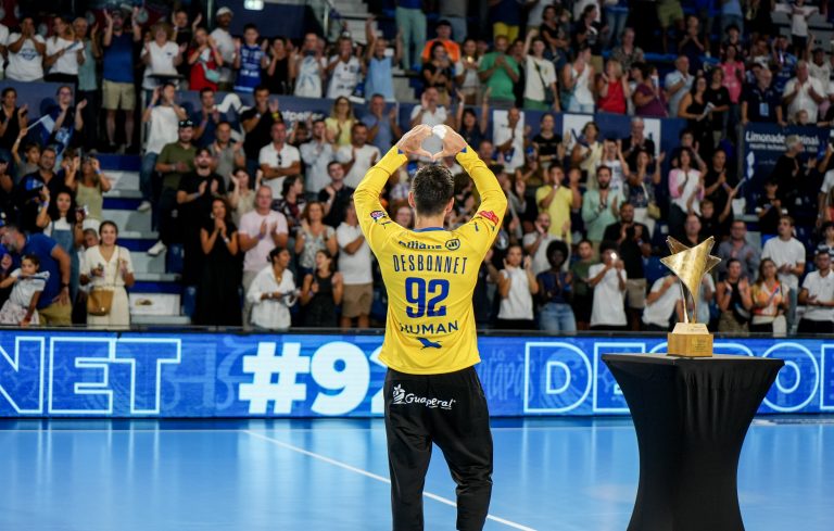 Joueur de handball célébrant devant le public.